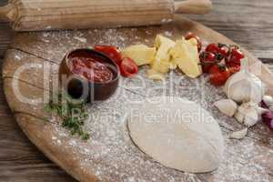 Pizza dough, flour, rolling pin, with ingredient