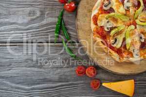 Various species with pizza arranged on wooden tray