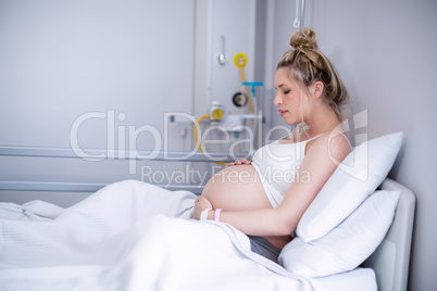 Pregnant woman relaxing on hospital bed