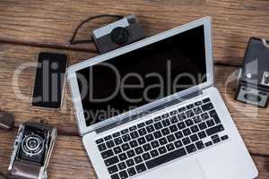 Close-up of laptop with cameras on table