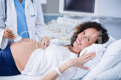 Pregnant woman receiving a ultrasound scan on the stomach