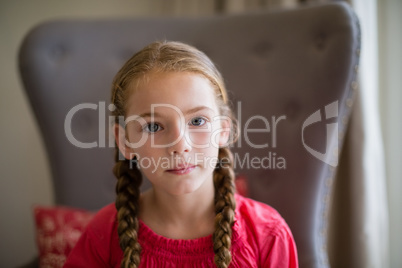 Portrait of cute girl sitting on chair