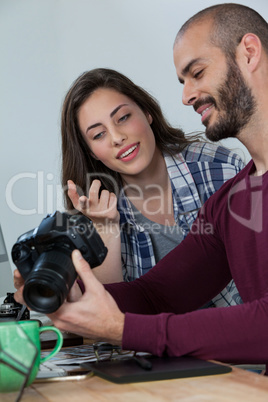 Photographers reviewing captured photos in his digital camera