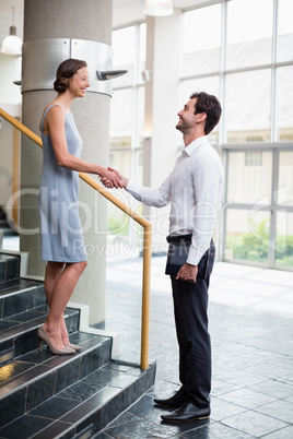 Business executives shaking hands with each other