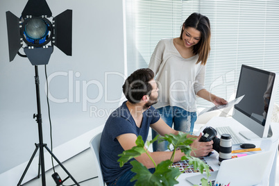 Photographers working together at desk