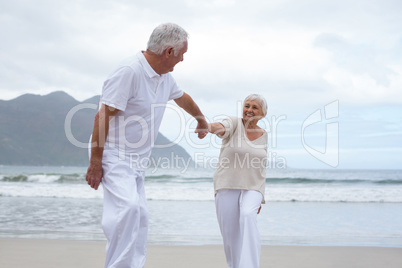 Senior couple having fun together at beach