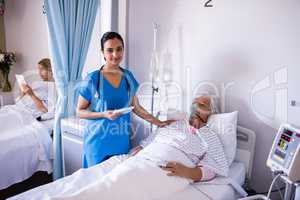 Female doctor consoling female senior patient