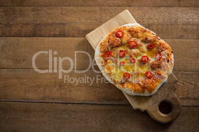 Pizza served on a chopping board