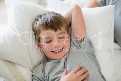 Cute boy sleeping on bed in bedroom