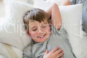 Cute boy sleeping on bed in bedroom