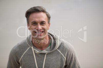 Smiling mature man standing on the beach