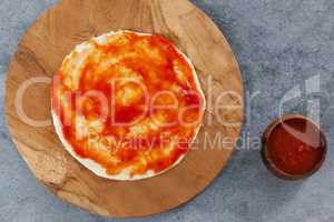 Pizza dough with tomato sauce