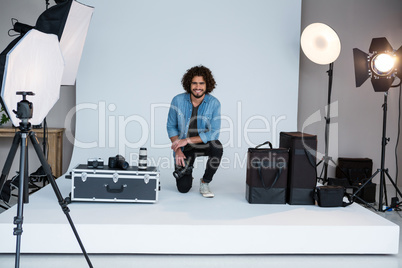 Happy male photographer in studio