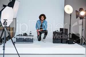 Happy male photographer in studio