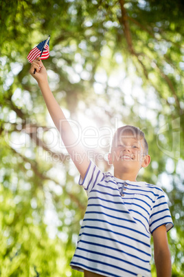 Boy holding small american flag