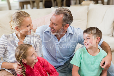 Happy parents and kids having fun in living room