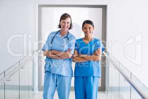 Portrait of smiling nurse and doctor standing with arms crossed