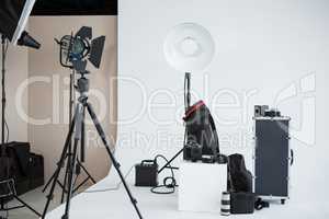 Photo studio with lighting equipment and digital camera
