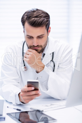 Male doctor using mobile phone