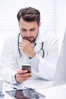 Male doctor using mobile phone