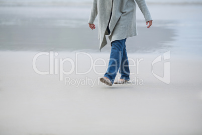 Senior woman walking near sea