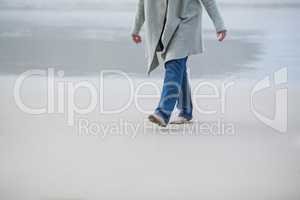 Senior woman walking near sea