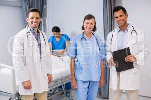 Portrait of doctors and nurse standing with medical report