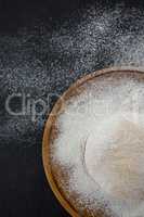 Pizza dough ball on a wooden tray