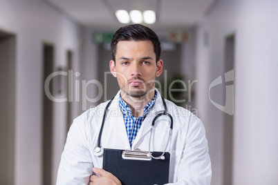 Portrait of doctor standing with clipboard