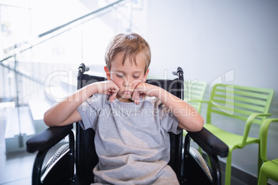 Sad boy patient sitting on a wheelchair