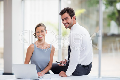Business executives with laptop at conference centre