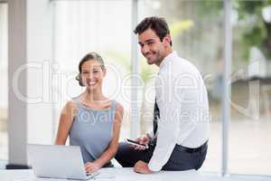 Business executives with laptop at conference centre