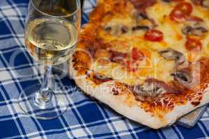 Delicious pizza with a glass of wine