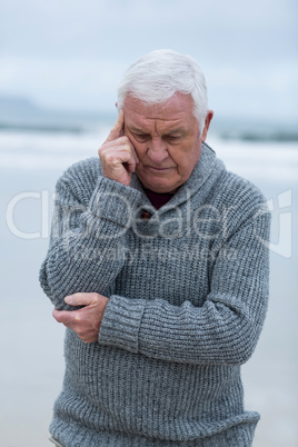 Senior man standing on the beach