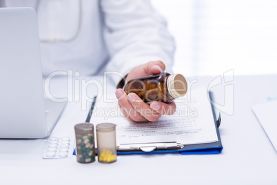 Mid section of male doctor checking medicine