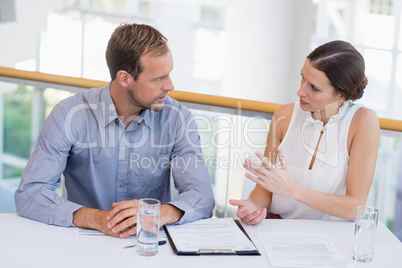 Business executives discussing over document