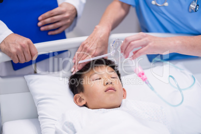 Doctor putting an oxygen mask on patient