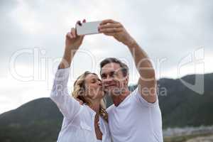 Mature couple taking selfie using mobile phone
