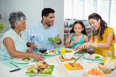 Happy multi generation family having meal on table