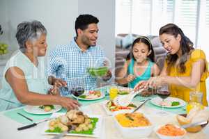 Happy multi generation family having meal on table