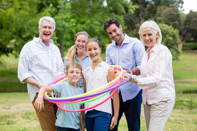 Multi-generation family playing with hula hoop