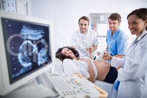 Doctor doing ultrasound scan for pregnant woman