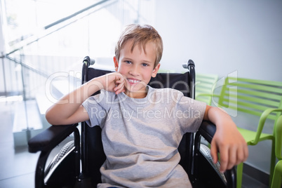 Portrait of smiling boy patient sitting on a wheelchair