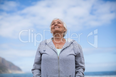 Senior woman standing on the beach