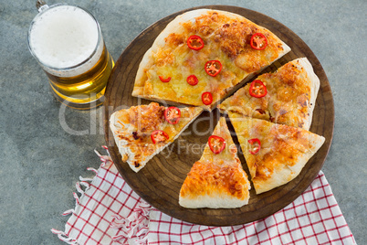 Pieces of italian pizza served with a mug of beer