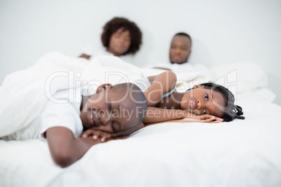 Parents and kids sleeping in bedroom