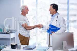 Doctor shaking hands with senior man