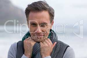 Smiling mature man standing on the beach