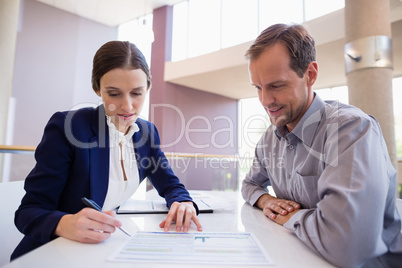 Business executives discussing over document