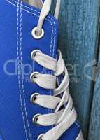 Detail of blue textile sneaker with white laces